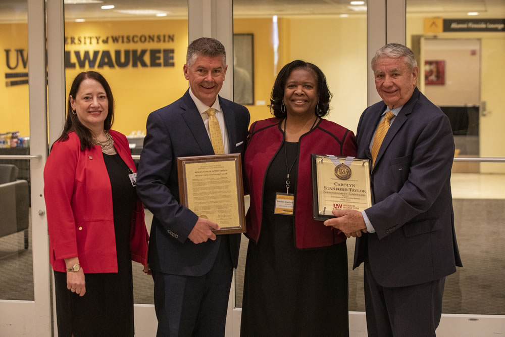 Photo of Regent Carolyn Stanford Taylor accepting her resolution of appreciation; (from left) Walsh, Petersen, Stanford Taylor, and Thompson