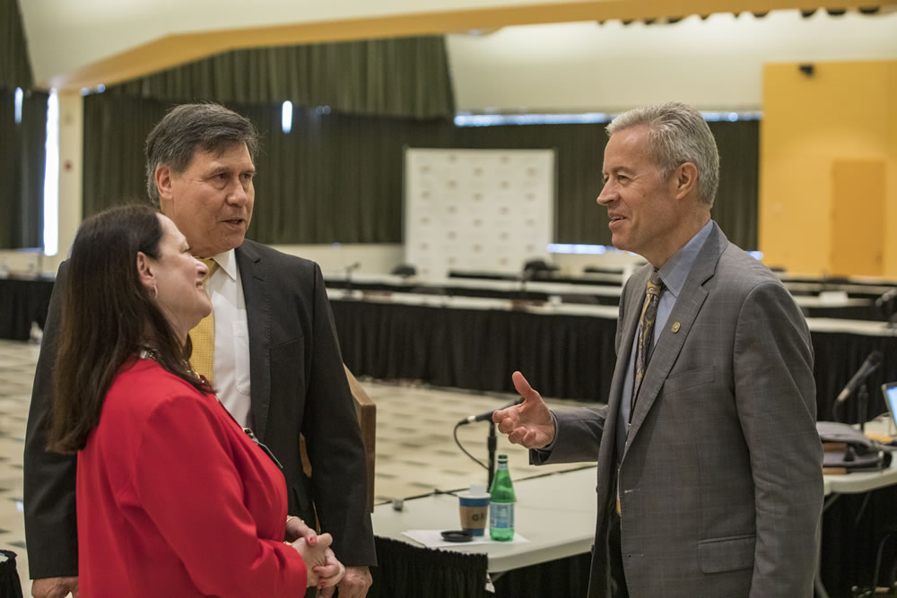 Photo of Regents Manydeeds and Walsh speaking with Chancellor Mone